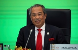 FILE - Malaysia?s Prime Minister Muhyiddin Yassin speaks during opening remarks for virtual APEC Economic Leaders Meeting 2020, in Kuala Lumpur, Malaysia, Nov. 20, 2020.