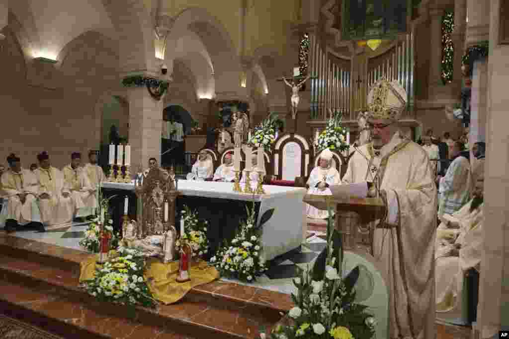 Latin Patriarch Pierbattista Pizzaballa leads the Christmas midnight Mass at the Church of the Nativity traditionally believed to be the birthplace of Jesus, in the West Bank city of Bethlehem, Dec. 24, 2024.