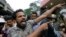 A supporter of newly appointed Sri Lankan prime minister Mahinda Rajapaksa shouts at police officers outside the Petroleum Ministry building in Colombo, Sri Lanka, Oct. 28, 2018. 