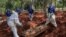 Workers bury a person believed to have died from COVID-19 at the Vila Formosa cemetery in the outskirts of Sao Paulo, Brazil, on March 31, 2020. 