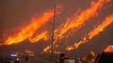 Members of a firefighting crew work to battle the Hughes Fire near Castaic Lake, north of Santa Clarita, California, Jan. 22, 2025. 