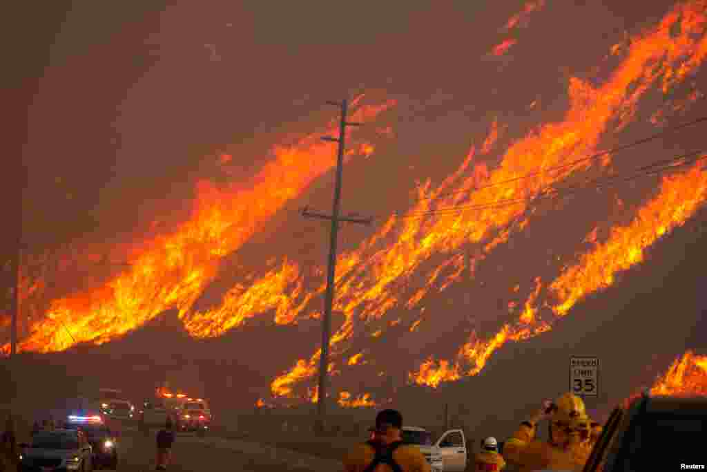 Members of a firefighting crew battle the Hughes Fire near Castaic Lake, north of Santa Clarita, California, Jan. 22, 2025.