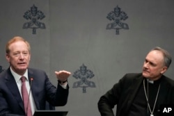 Cardinal Mauro Gambetti, right, and Microsoft's vice-Chairman and President Brad Smith unveil the project "St. Peter's Basilica: AI-Enhanced Experience" during a press conerence. at the Vatican, Monday, Nov. 11, 2024. (AP Photo/Gregorio Borgia)