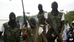 Members of Movement for the Emancipation for the Niger Delta, (MEND) a militant group patrol the creeks in the Niger Delta area of Nigeria, in this Feb. 24, 2006 file photo.