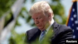 U.S. President Donald Trump bows his head in prayer at the United States Coast Guard Academy Commencement Ceremony in New London, Connecticut, May 17 2017.