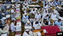 FILE - In this picture taken on Oct. 19, 2020 Islamic seminary students attend class at the Darul Uloom Haqqania seminary in Akora Khattak. Haqqania, with several thousand students, is among South Asia's largest and most respected Islamic seminaries.