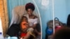 FILE - Ado Ntanga, 23, holds her son, Adrielle Nyembwe, 3, who was admitted to the Medicare Policlinic with Sickle Cell Anemia in Lubumbashi, Democratic Republic of the Congo.