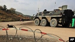 German troops serving in the NATO-led peacekeeping mission in Kosovo patrol near the Serb erected barricade in the village of Zupce, October 26, 2011.