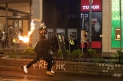 A demonstrator throws a Molotov cocktail at police during a protest in Hong Kong, Aug. 31, 2019.