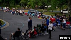 People line up outside Kentucky Career Center prior to its opening to find assistance with their unemployment claims in Frankfort, Kentucky, U.S. June 18, 2020. 