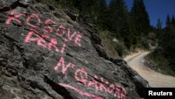 Graffiti, which reads: "Kosovo to Qakorr" (regarding demarcation of the border with Montenegro), is pictured at a crossroad in the village of Haxaj, Peja, in Kosovo, near the border with Montenegro, Aug. 28, 2016.