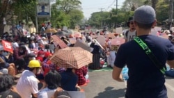 Protesters opposed to the military coup block a street next to the central bank in Yangon, Myanmar, Feb. 16, 2021 in this still image taken from a video obtained by Reuters.