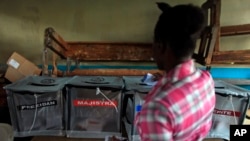 FILE - A woman casts her ballot at a polling station during elections in the Petion-Ville suburb of Port-au-Prince, Haiti, Oct. 25, 2015. 