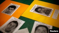 Pictures of students from the Ayotzinapa Teacher Training College "Raul Isidro Burgos", who have been missing since last month's deadly clashes, are seen during a vigil at the Instituto Tecnologico Autonomo de Mexico (ITAM) in Mexico City, October 14, 201