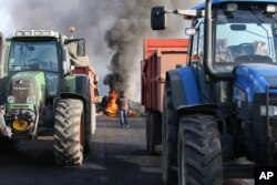 FILE - French farmers block the RN12 road near Guingamp, western France, Jan. 22, 2016.