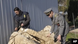 Guardia di Finanza police officers inspect a statue believed to be that of Roman emperor Caligula in Nemi, north of Rome in this January 2011 handout photo.