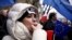 A woman whistles during an anti-government demonstration in front of the Constitutional Court in Warsaw, Poland, Dec. 12, 2015. 