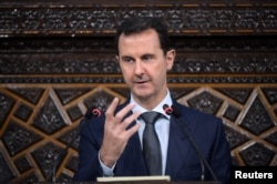 Syrian President Bashar al-Assad speaks to Parliament members in Damascus in this photo handed out by SANA, the Syrian Arab News Agency, June 7, 2016.
