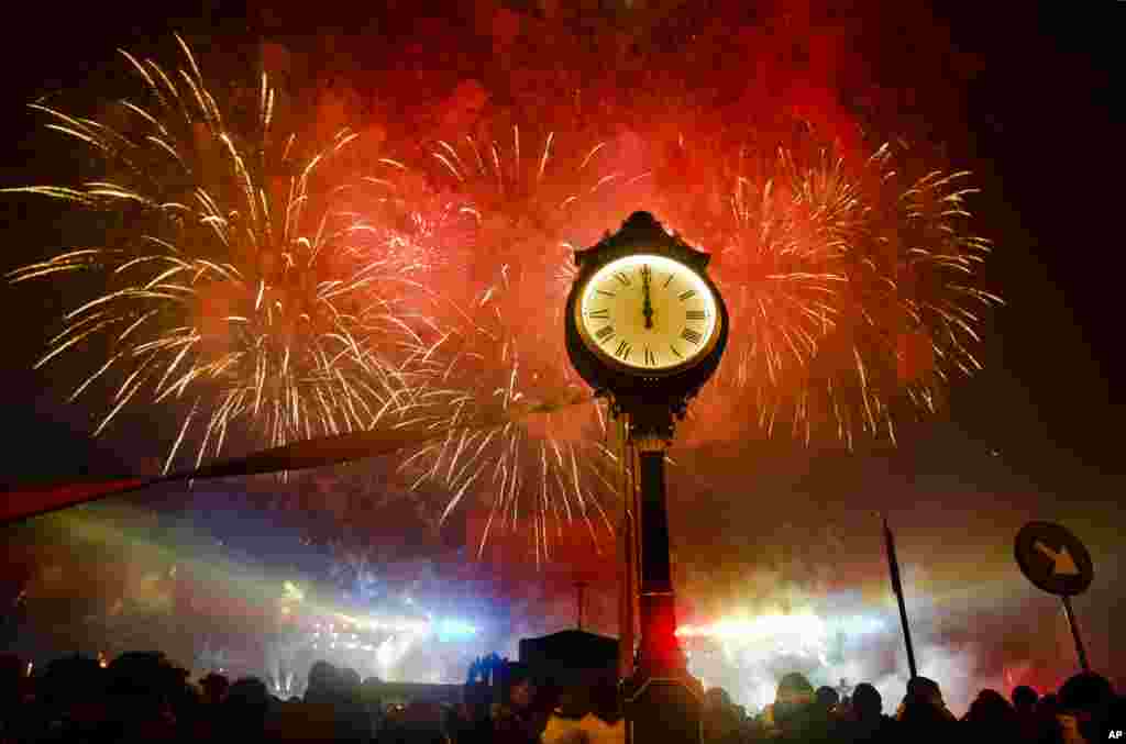 Fireworks explode in the sky over Bucharest, Romania, at midnight, Sunday, Jan. 1, 2012, during street celebrations of the new year. Large crowds gathered, taking advantage of the dry weather to attend the celebrations.(AP)