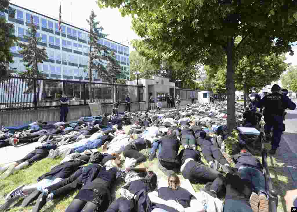 Pepole protest against racism in front of the U.S. Embassy in Otwock, Poland, Thursday, June 4, 2020 in reaction to the death of George Floyd. (AP Photo/Czarek Sokolowski)