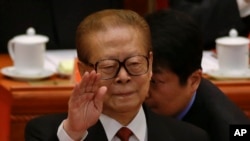 FILE - Former Chinese President Jiang Zemin gestures during the opening session of the 18th Communist Party Congress held at the Great Hall of the People in Beijing, China, Nov. 8, 2012. 