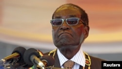 FILE: President Robert Mugabe waits to address crowds gathered for Zimbabwe's Heroes Day commemorations in Harare, August 10, 2015.