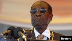 FILE: President Robert Mugabe waits to address crowds gathered for Zimbabwe's Heroes Day commemorations in Harare, August 10, 2015.