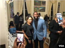NFL star, Haitian-American Pierre Garcon poses for a photo with Miss Black America, Brittany Lewis at the Haitian Embassy's fashion event in Washington, D.C., Feb 23, 2018. (VOA / S. Lemaire)