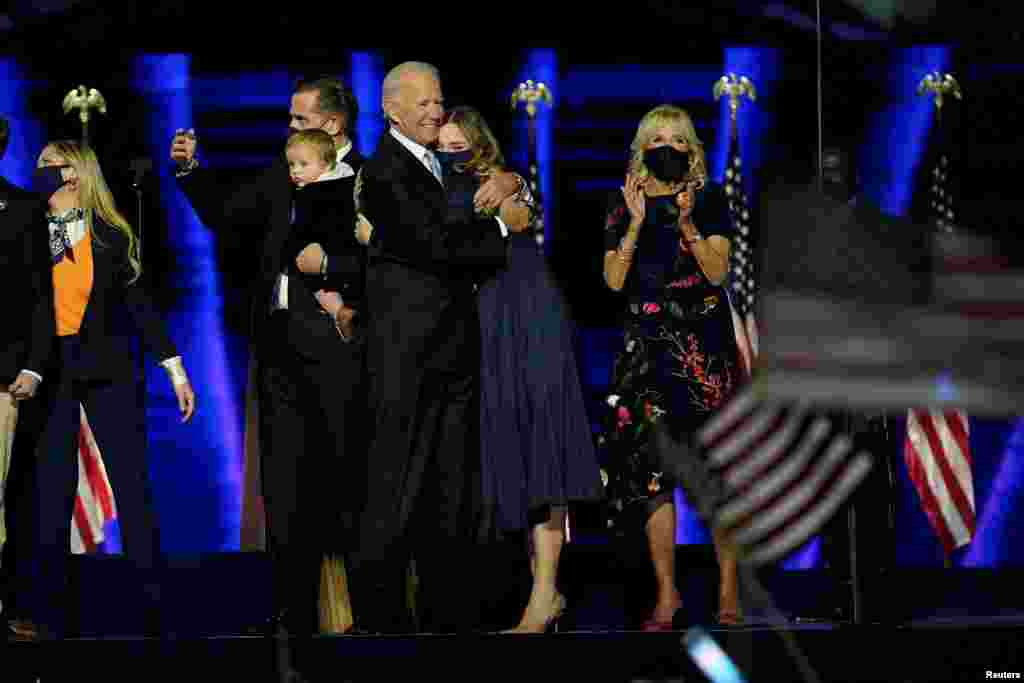 Democratic 2020 U.S. presidential nominee Joe Biden is accompanied on the stage by his wife Jill, and members of their family, after speaking during his election rally.