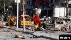 A Somali woman walks in front of Hotel Ambassador on Maka Al Mukaram Road in Somalia's capital Mogadishu, June 2, 2016. 