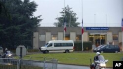 The funeral convoy leaves with the coffins of French nationals Vincent Delory and Antoine De Leocour, abducted and killed in Niger over the weekend, after their arrival at Paris' Roissy Charles de Gaulle airport, 12 Jan 2011