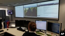 FILE - A naval officer works at the operation room of the EU NAVFOR, the European Union naval force responsible with anti-piracy patrols, at their headquarters in Northwood, England.