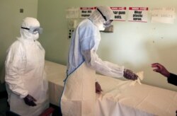 Zimbabwe's health workers wear protective suits during a training exercise aimed at preparing workers to deal with any potential coronavirus cases at a hospital in Harare, Zimbabwe, Feb. 14, 2020.