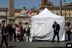Citizens line up at a makeshift gazebo set up around the country for the Democratic party's primary elections, in Rome, Italy, April 30, 2017.