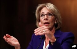 FILE - Betsy DeVos testifies on Capitol Hill in Washington, Jan. 17, 2017, at her confirmation hearing before the Senate Health, Education, Labor and Pensions Committee.