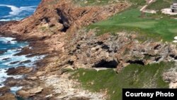 The excavation site is at Pinnacle Point, Mossel Bay, on the southern coast of South Africa. The cave opening is in the center of this image. (Photo: Erich Fisher)