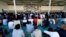 FILE - Migrants attend prayers at a detention center in Tripoli, Libya, June 15, 2018.