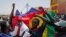 FILE - Protesters hold Russian and Senegalese flags during a Feb. 24, 2024, protest against the postponement of the presidential election scheduled for Feb. 25, in Dakar, Senegal. A commission on Feb. 27 recommended that the delayed election be held in early June.