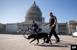 U.S. Capitol Police officers keep watch over the East Front of the Capitol as Congress prepares to return to work following the weekend terror attacks in Paris that killed 129 people, in Washington, Nov. 16, 2015.