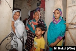 Family members of Habibur Rahman, at their Chittagong home, a day after he was killed during the ongoing anti-drug campaign in Bangladesh. The young girl is Rahman's daughter Sanjida Rahman Eva and the boy is his son. "My father was framed in drugs cases and killed in a fake crossfire all because he was a political activist opposing the government," Eva said.