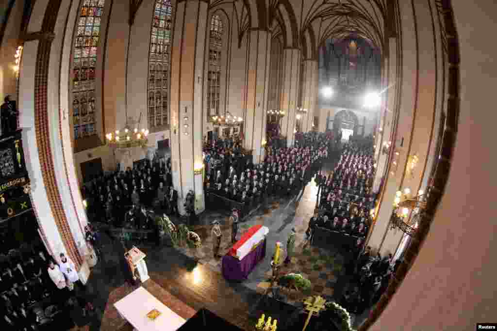 The coffin of Poland's first non-communist prime minister Tadeusz Mazowiecki is seen covered with a Polish national flag during his funeral at St. John's Archcathedral in Warsaw. 