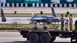 FILE - Pakistan's first locally manufactured armed drone aircraft is loaded on a vehicle during the Pakistan National Day parade in Islamabad, Pakistan, March 23, 2015.