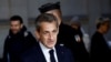 FILE - Former French President Nicolas Sarkozy arrives for his appeal trial on charges of corruption and influence peddling, at Paris courthouse, France, Dec. 15, 2022. 