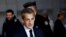 FILE - Former French President Nicolas Sarkozy arrives for his appeal trial on charges of corruption and influence peddling, at Paris courthouse, France, Dec. 15, 2022. 