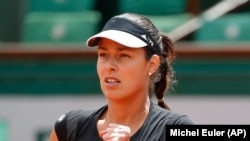 Serbia's Ana Ivanovic clenches her fist after scoring a point as she plays Ukraine's Elina Svitolina during their quarterfinal match of the French Open tennis tournament in Paris, France