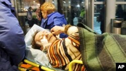 Medics wheel a victim of a bomb explosion at Moscow's Domodedovo airport, 24 Jan 2011