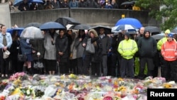 People near the scene of the recent attack observe a minute's silence in tribute to the victims of the attack at London Bridge and Borough Market, in central London, June 6, 2017. 