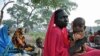 Refugees wait for food aid to be distributed near the volatile border with the north, in Yida refugee camp in South Sudan, November 16, 2011.