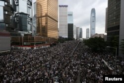 Protesters march along a road demonstrating against a proposed extradition bill in Hong Kong, June 12, 2019.