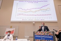 Jonathan Wilson, COVID Incident Manager at the University of Mississippi Medical Center, right, speaks about the impact of the recent spike in COVID-19 hospitalizations, July 9, 2020 in Jackson Miss.